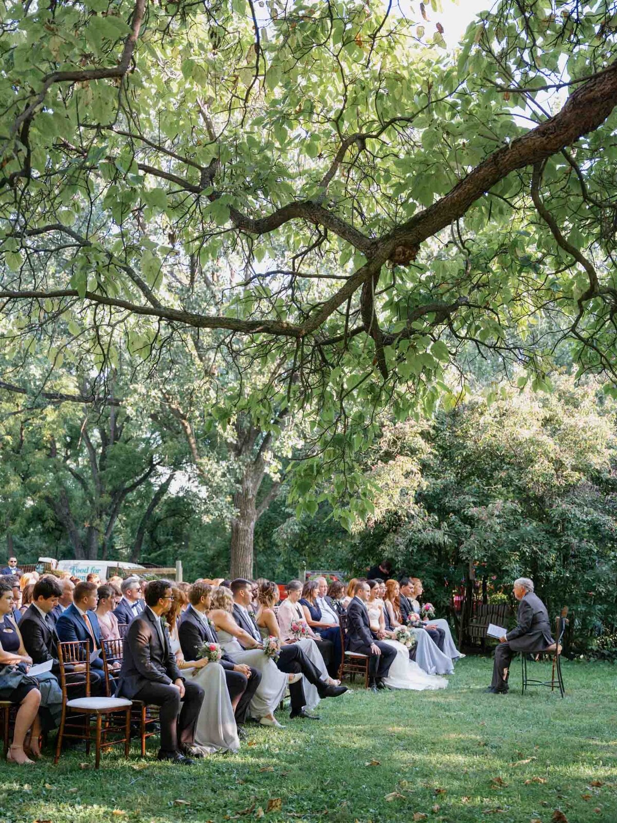 Outdoor wedding ceremony under clear blue sky.