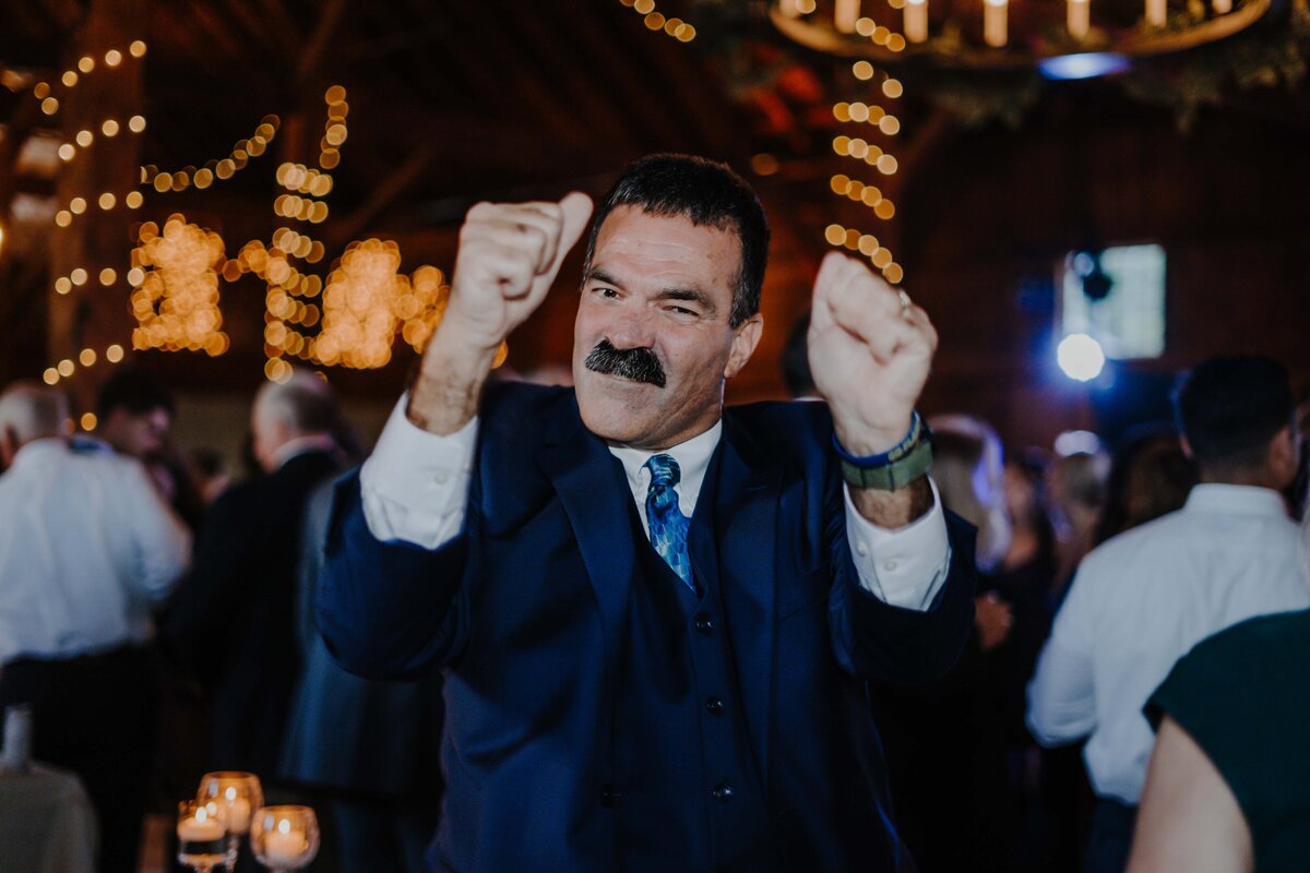 a man at a wedding reception dancing