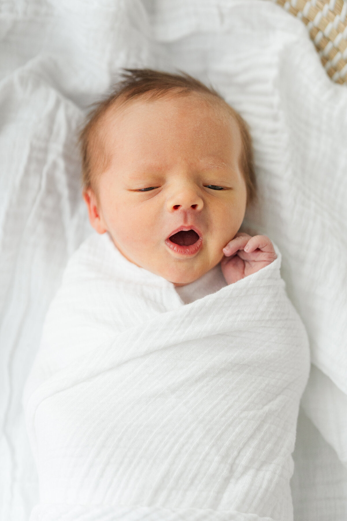 A Minneapolis newborn photographer captures a sweet moment of a baby yawning