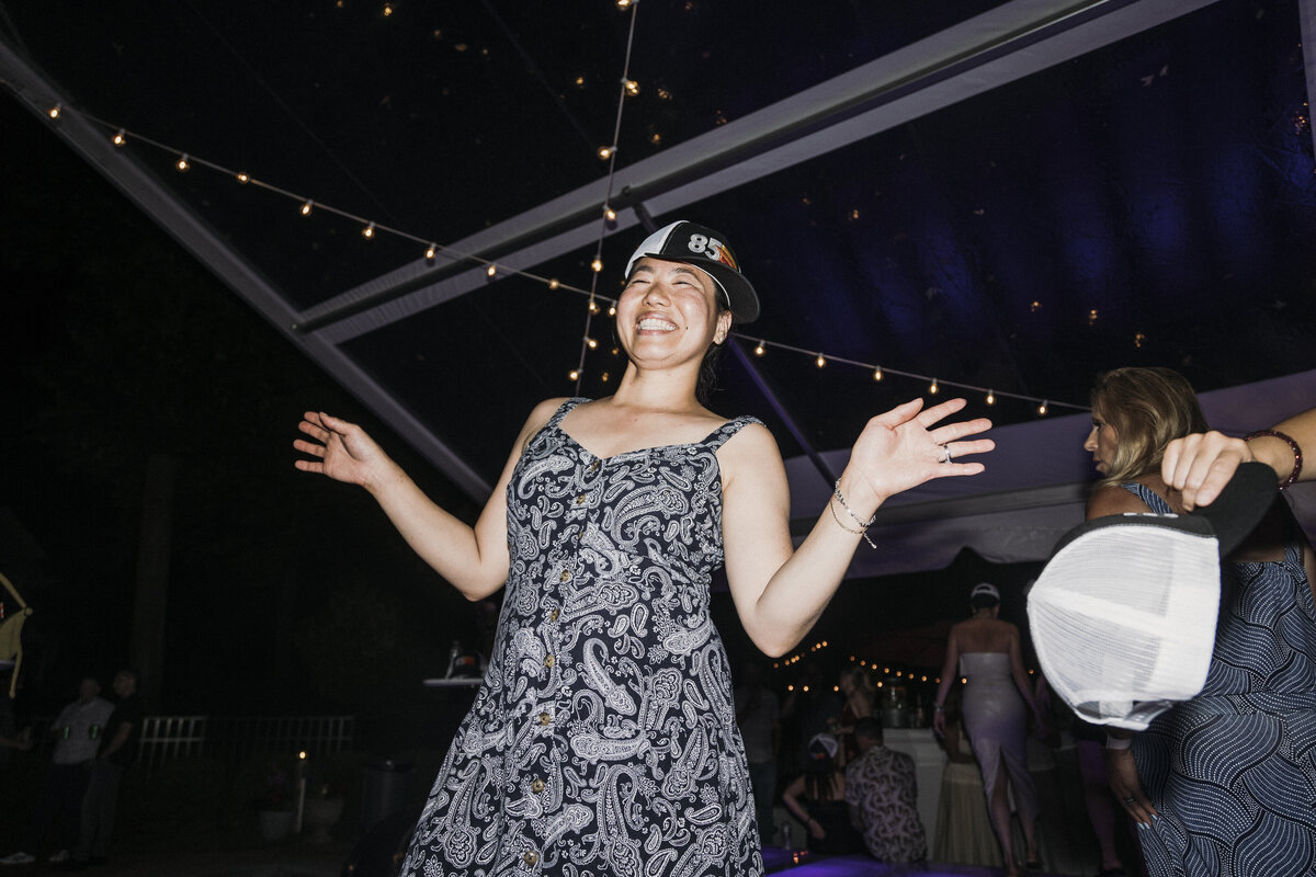 Photo of guest dancing in private backyard party by Mira Park Photography NY based wedding photographer