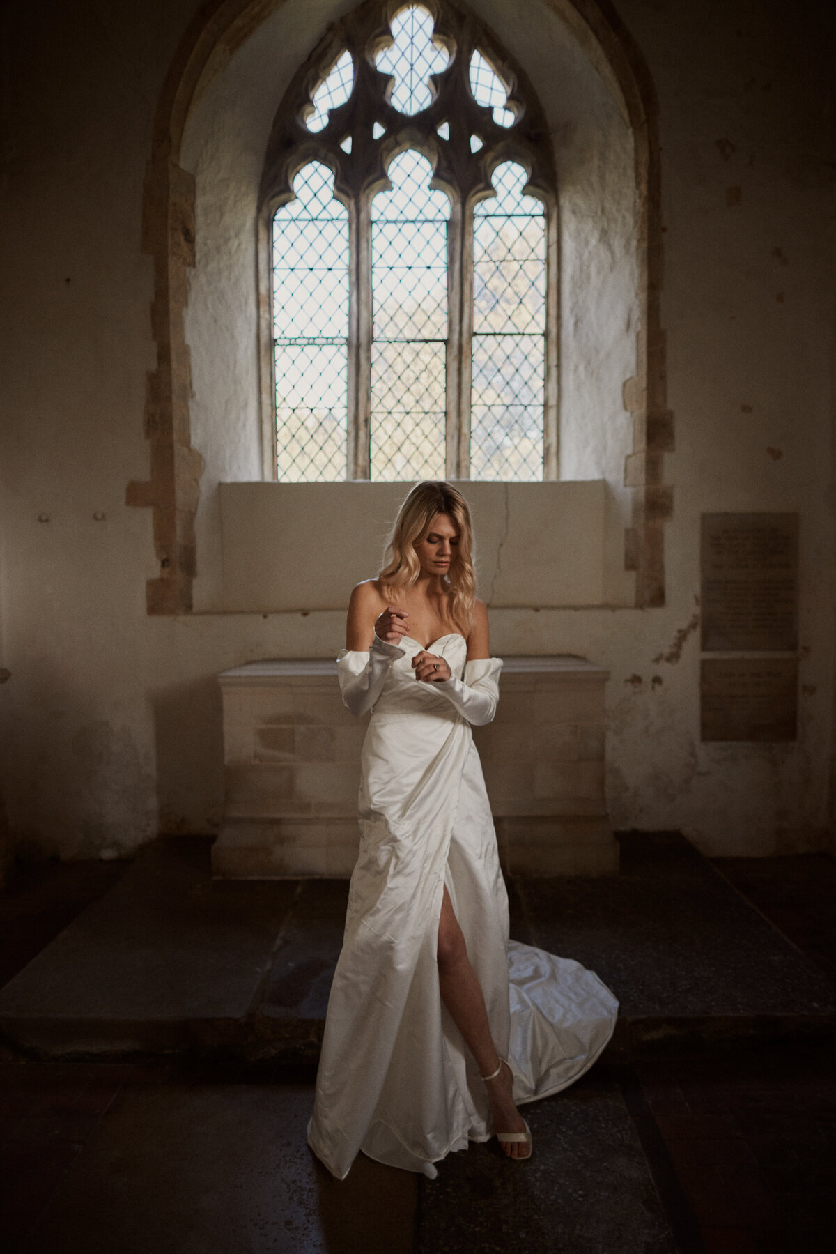 Bride wearing silk corset wedding dress in chapel