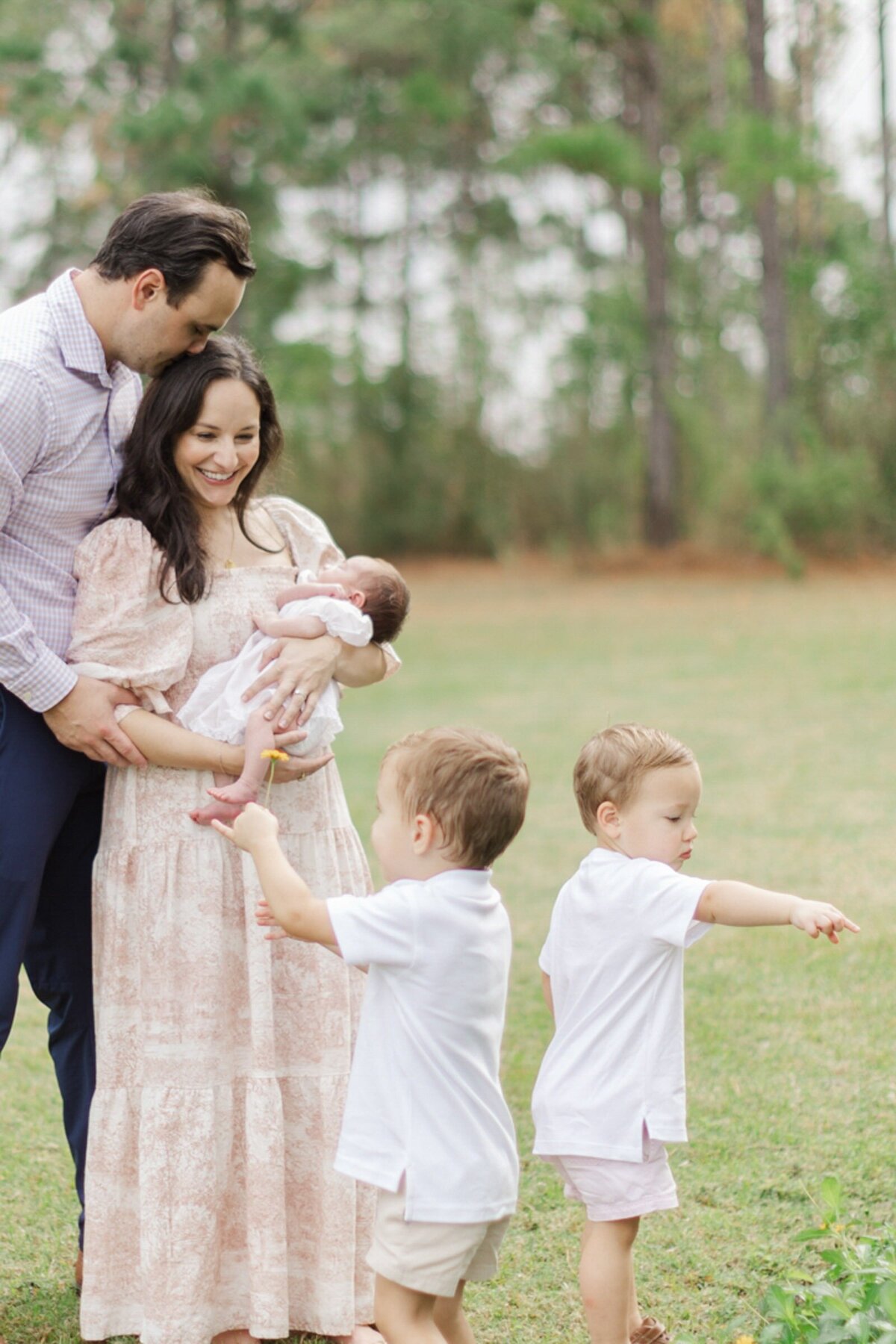 family plays together outside exploring houston nature
