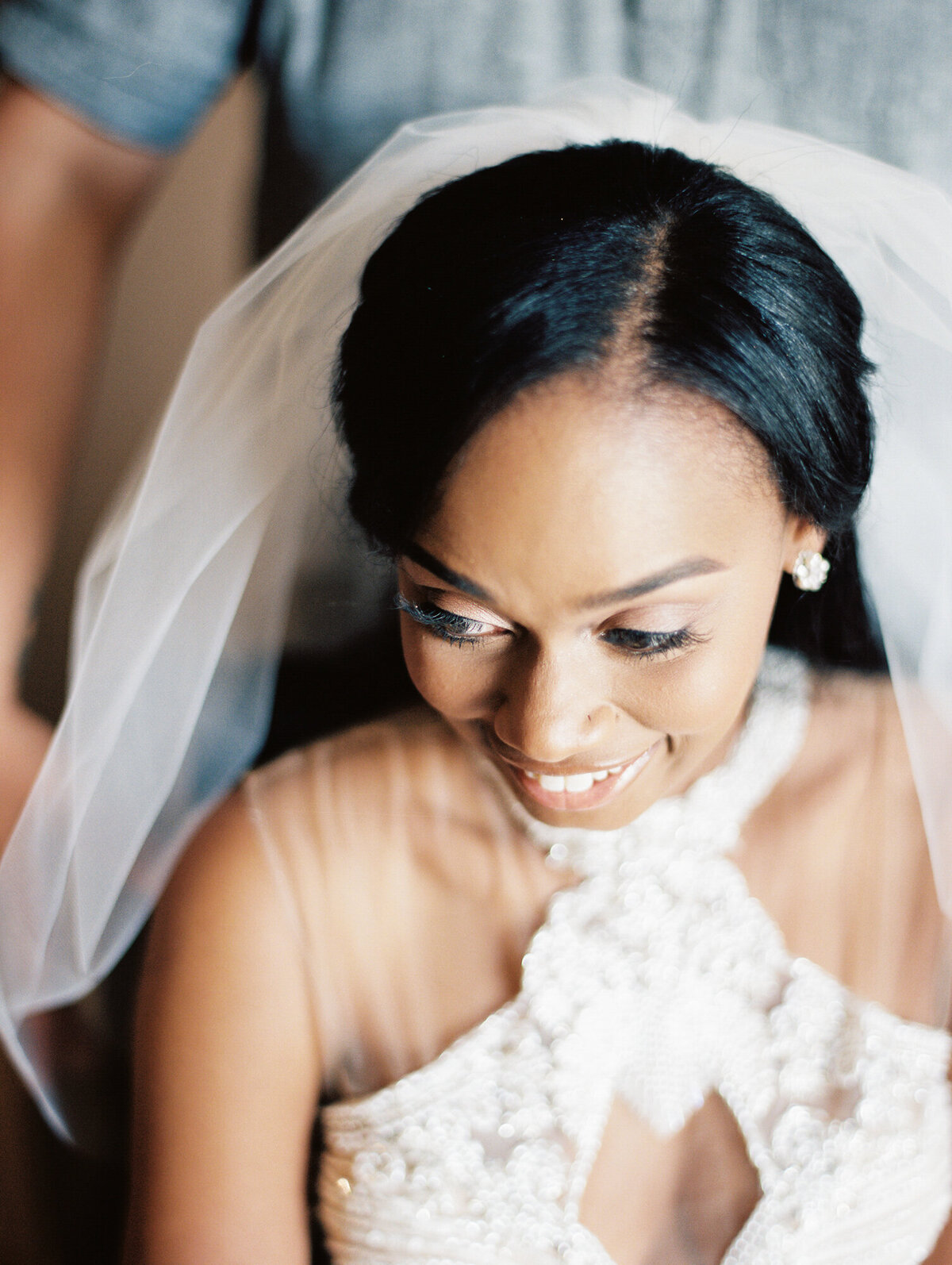 Bride inserting wedding veil in hair