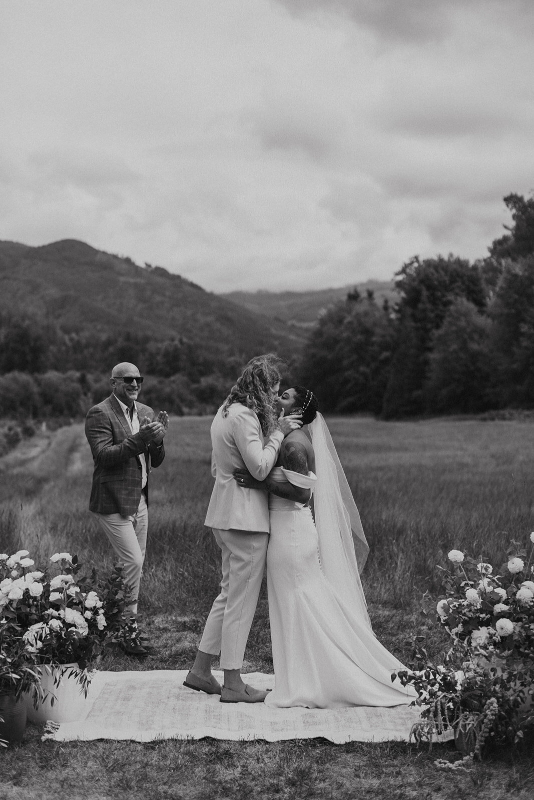 Black & White photo of 2 brides kissing during their intimate wedding ceremony near Mount Baker!