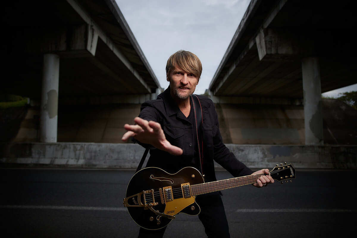 commercial photo of Musician Eddie Skiba posing with guitar