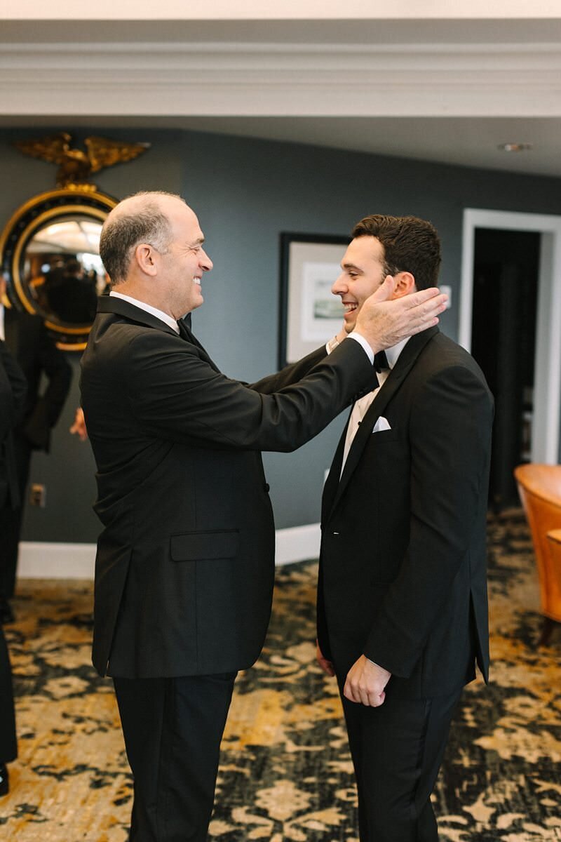 groom-buttoning-suit-jacket-evansville-country-club16