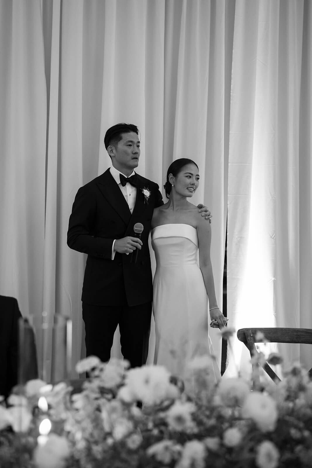 Bride and groom share a hug after speeches conclude at the Aspen Meadows Resort reception venue in Colorado.