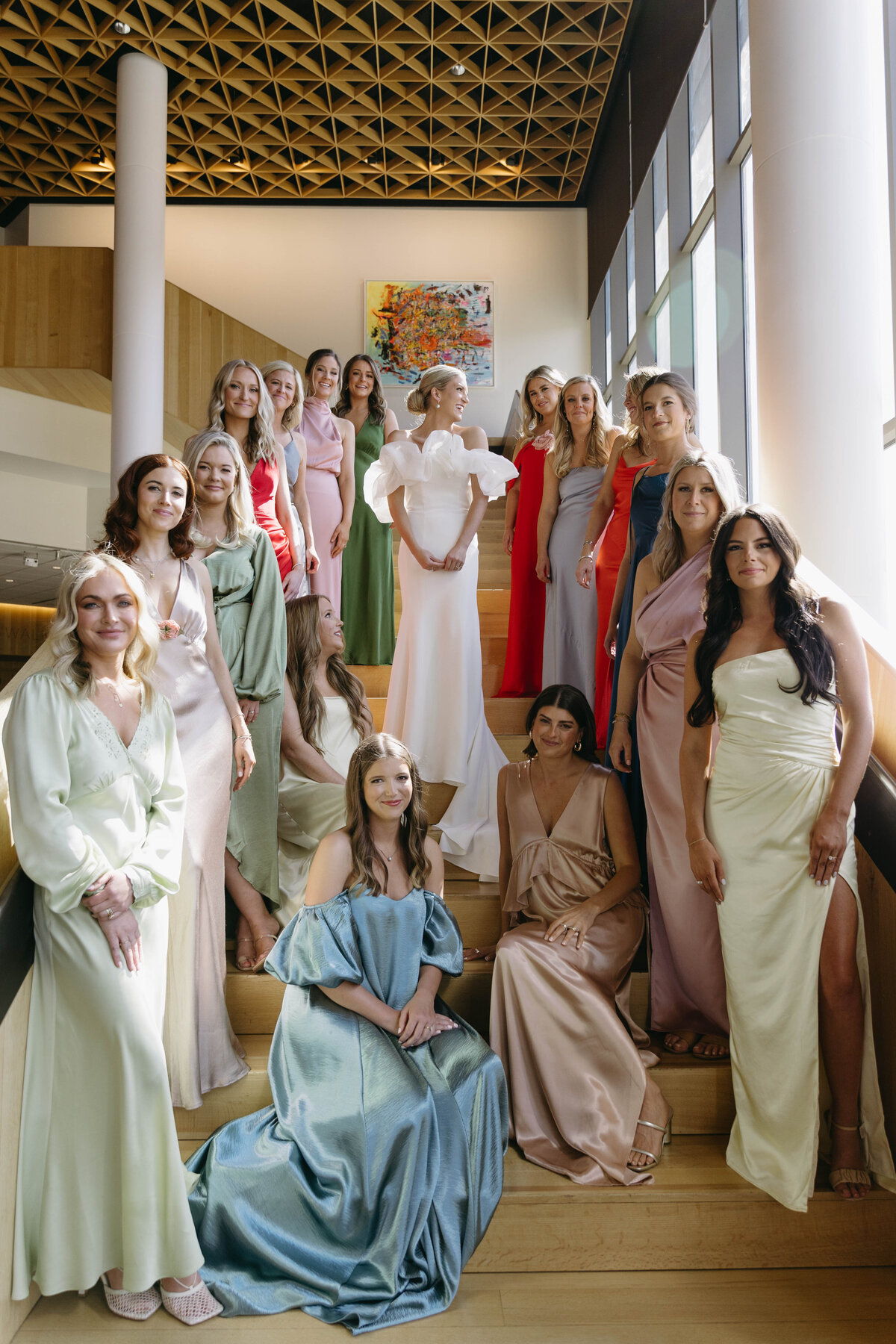 Modern bridal party in pastel gowns celebrating Clar Barron Photo wedding