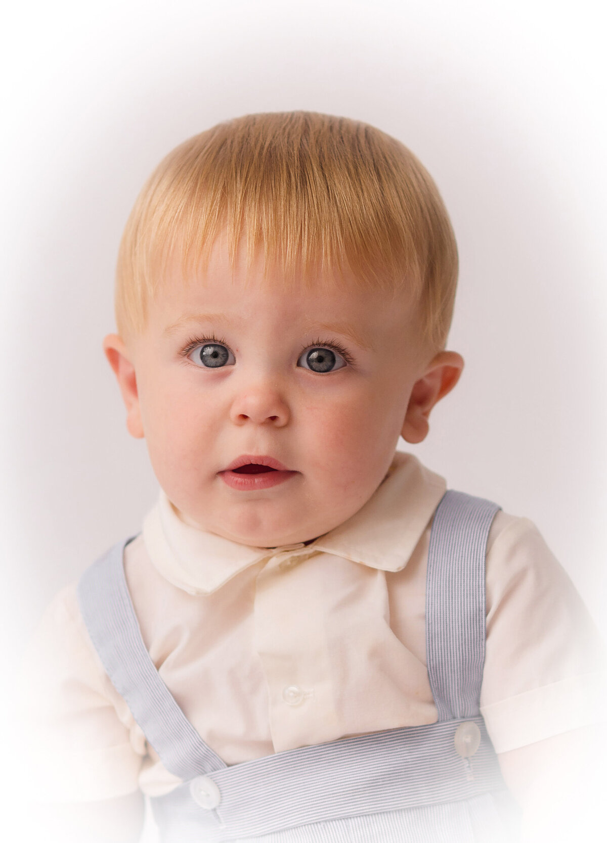 Baby peers into the camera during Heirloom Portrait Session in Charleston.