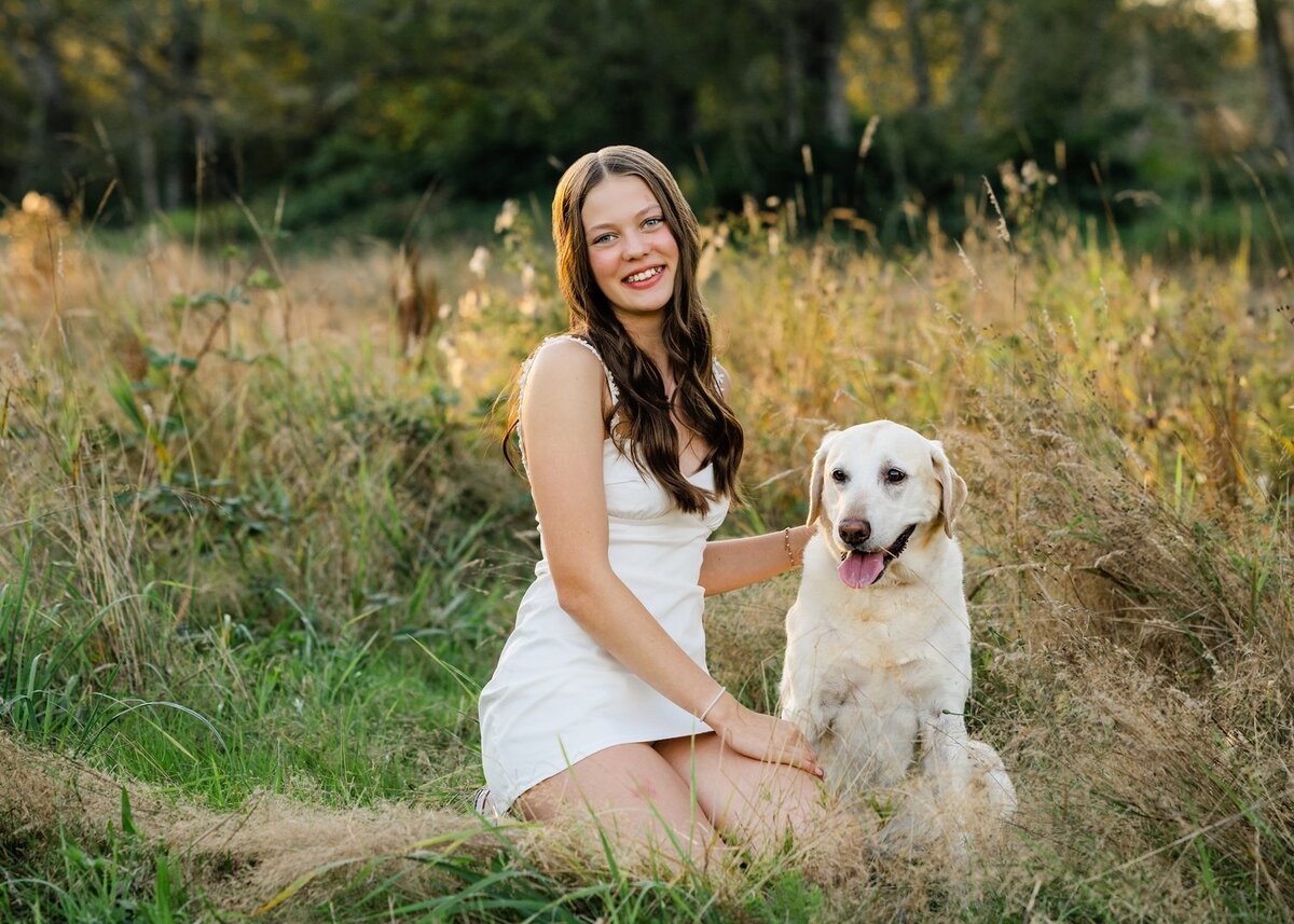 north bend senior with dog seated in field