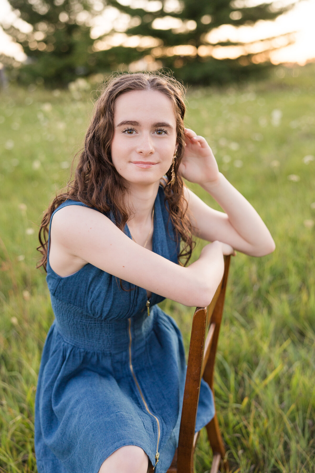 Senior girl seated on a chair smiling at the camera