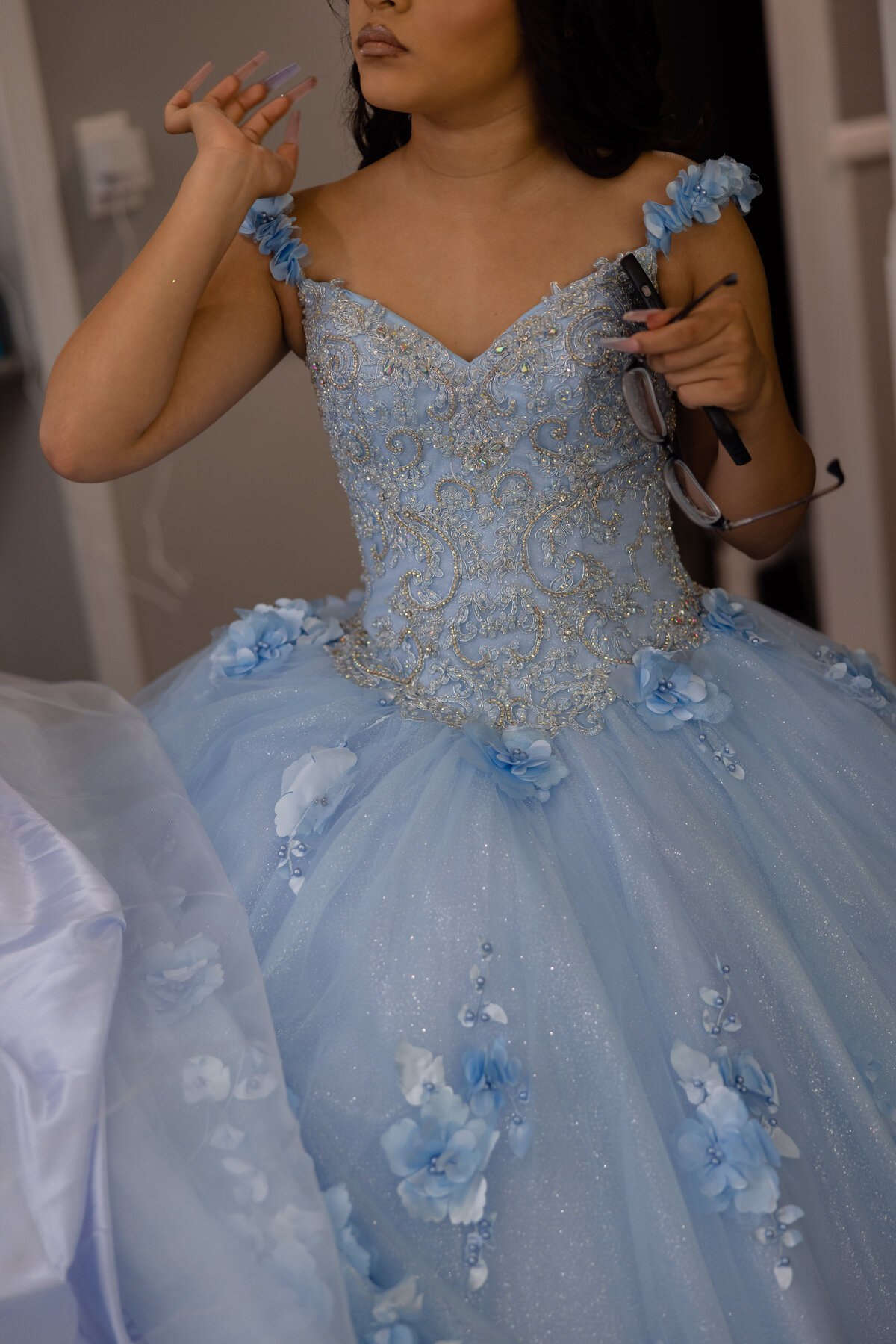 A heartfelt moment during Victoria’s quinceañera ceremony at the Palmer Astrodome, filled with love and tradition.
