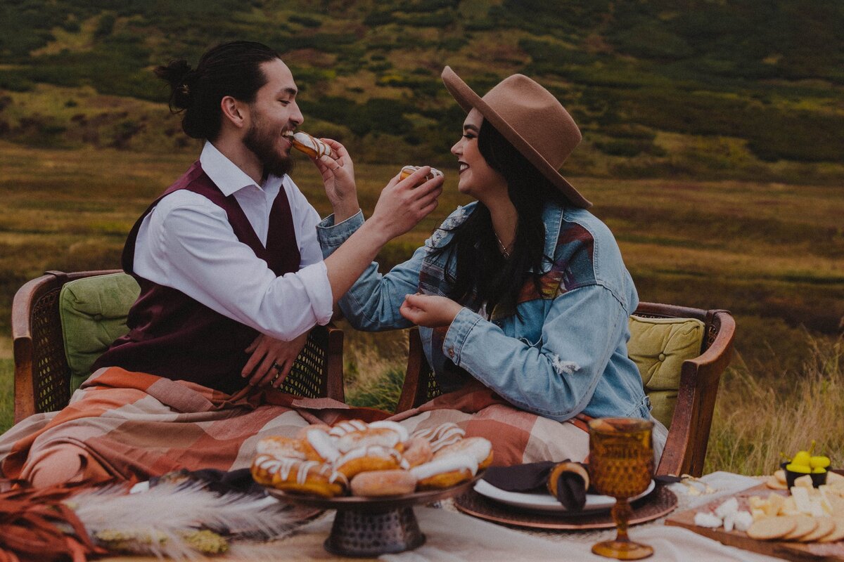 A newlywed couple enjoys donuts for their treat on their elopement day