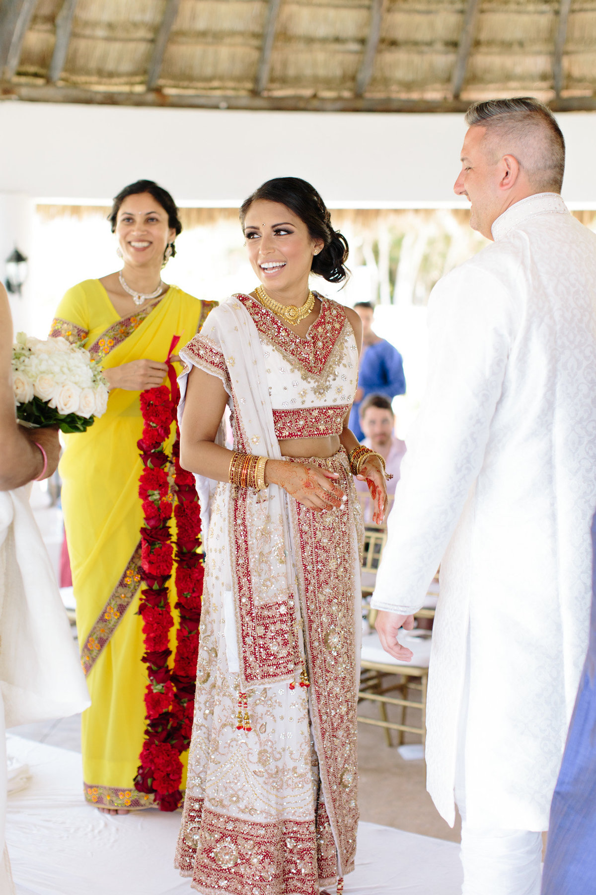 A bride is glowing in her sari.  Emotion captured by top destination photographer Rebecca Cerasani.