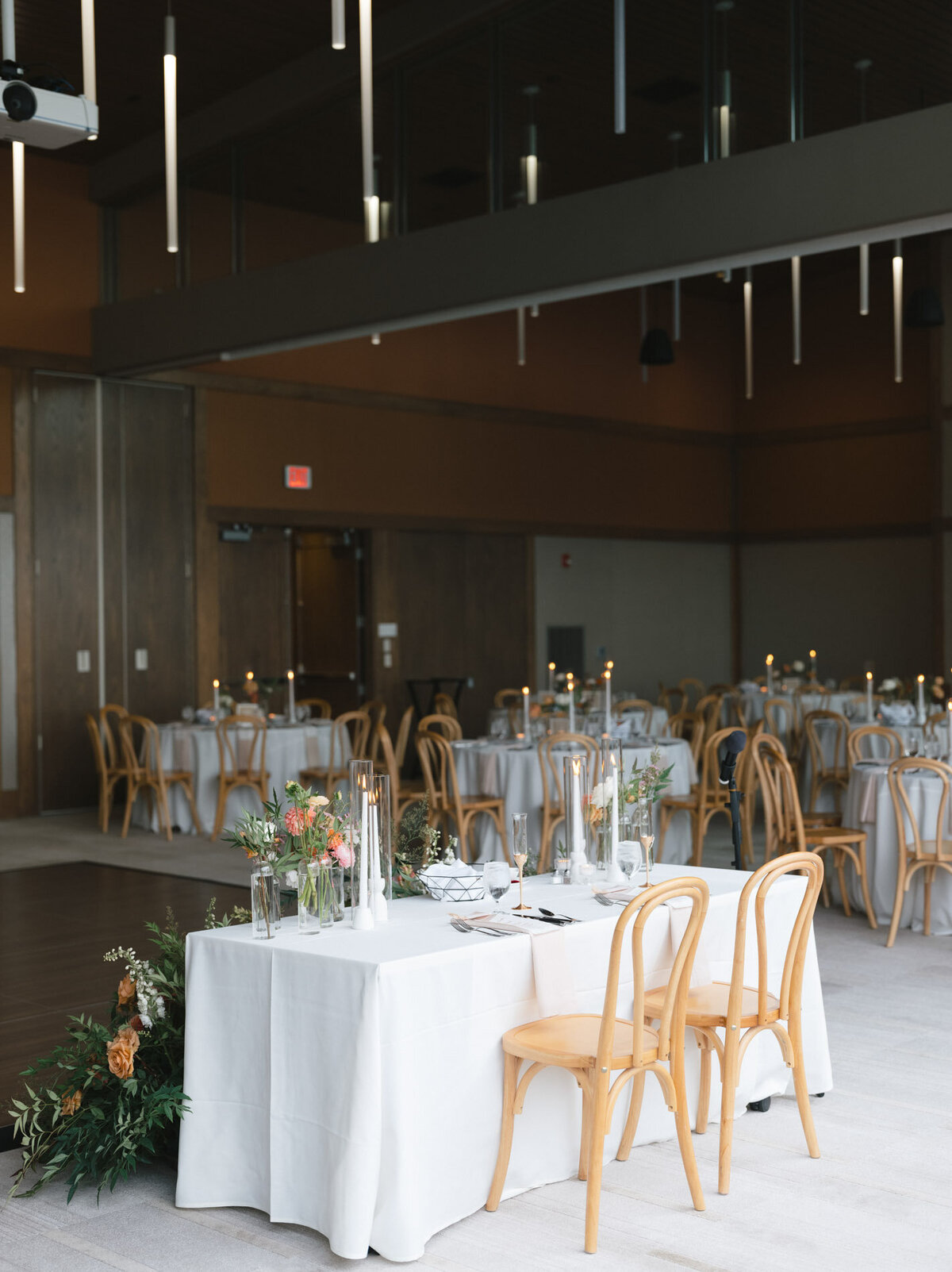 wedding table for bride and groom in reception space at an oregon venue with florals and wood chairs representing full service design and calligraphy by Life in Letters.