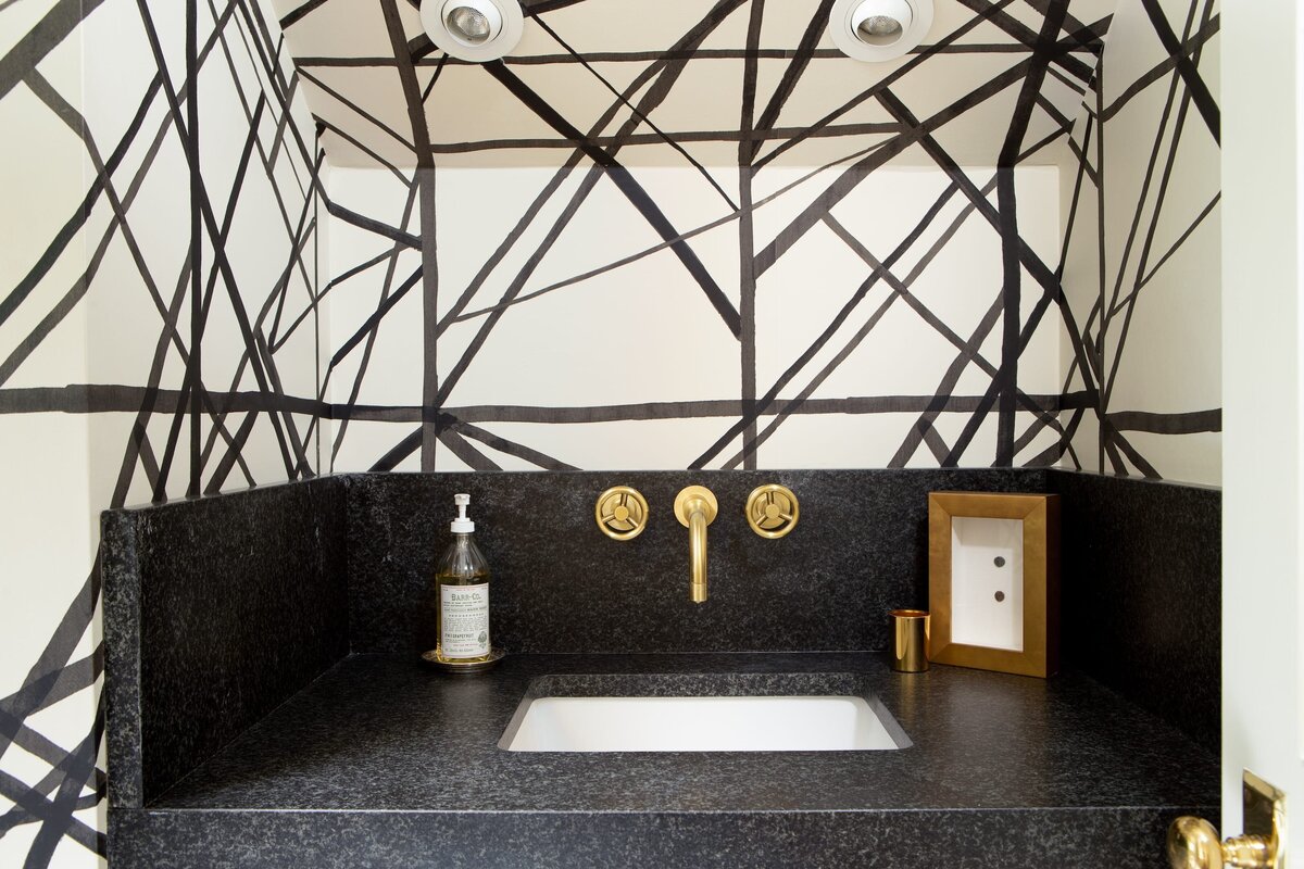 the keeping room interiors alta bathroom sink with black counter top and black and white wall