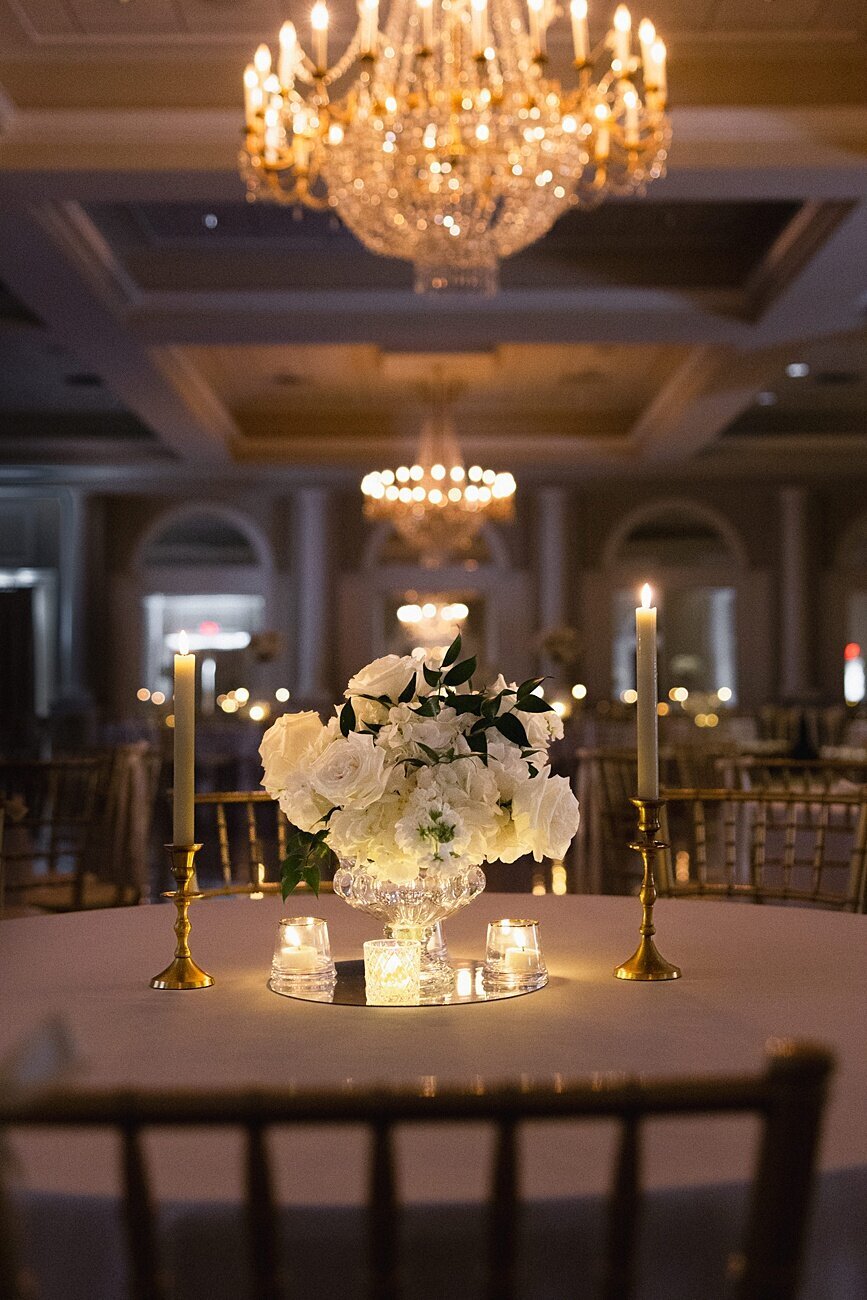 wedding reception table dimly lit with bouquet and faux candles