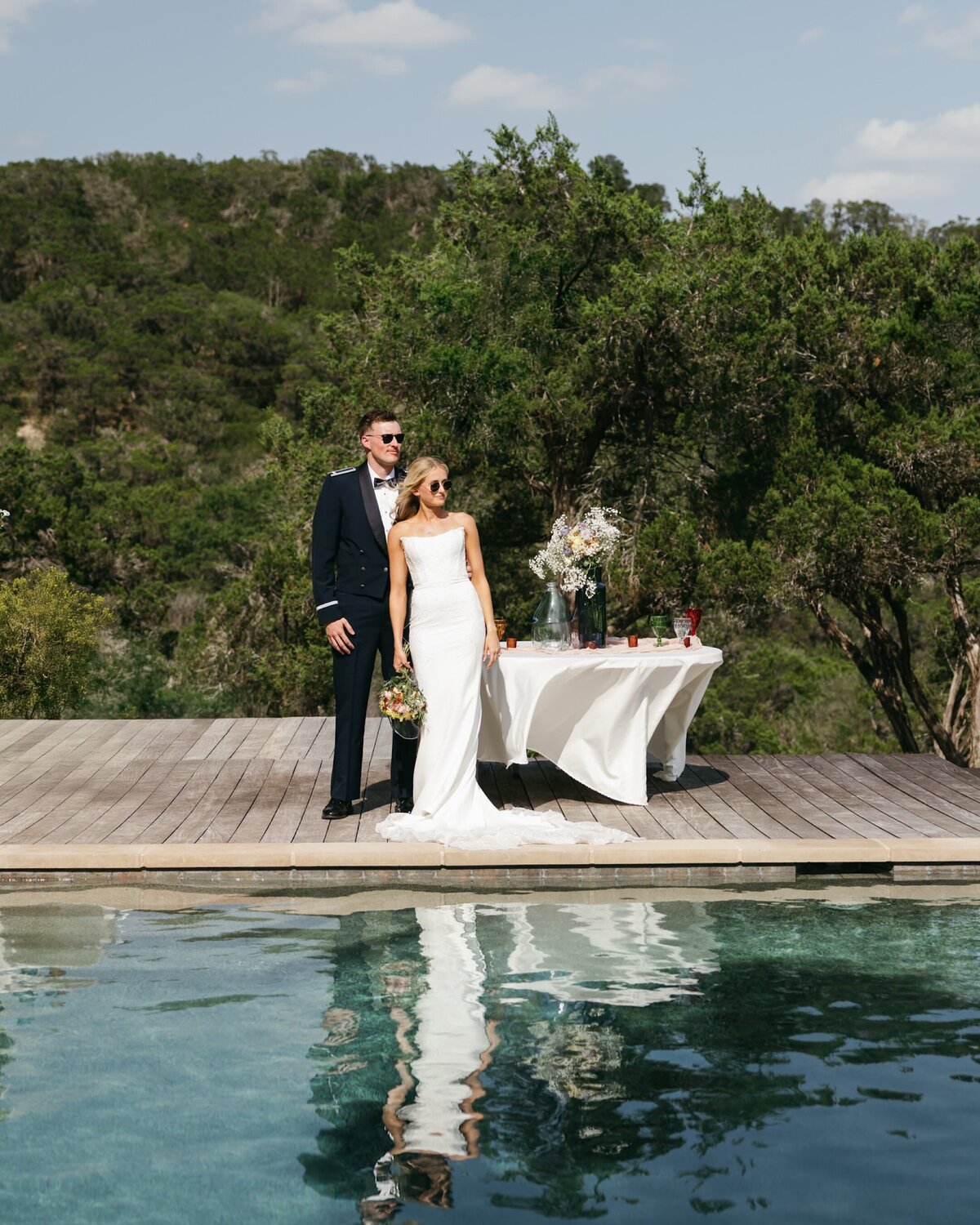 Wedding photographer takes photo of bride and groom in texas hill country. 
