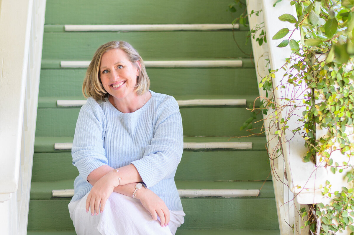 Boise photographer Tiffany Hix sitting on stairs in Palm Springs, CA.