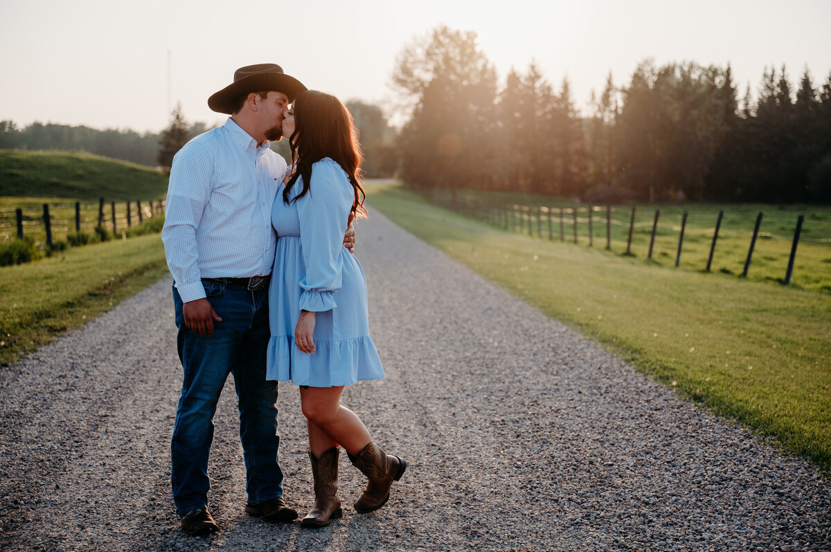 engaged couple do photo shoot with cowboy hats and boots