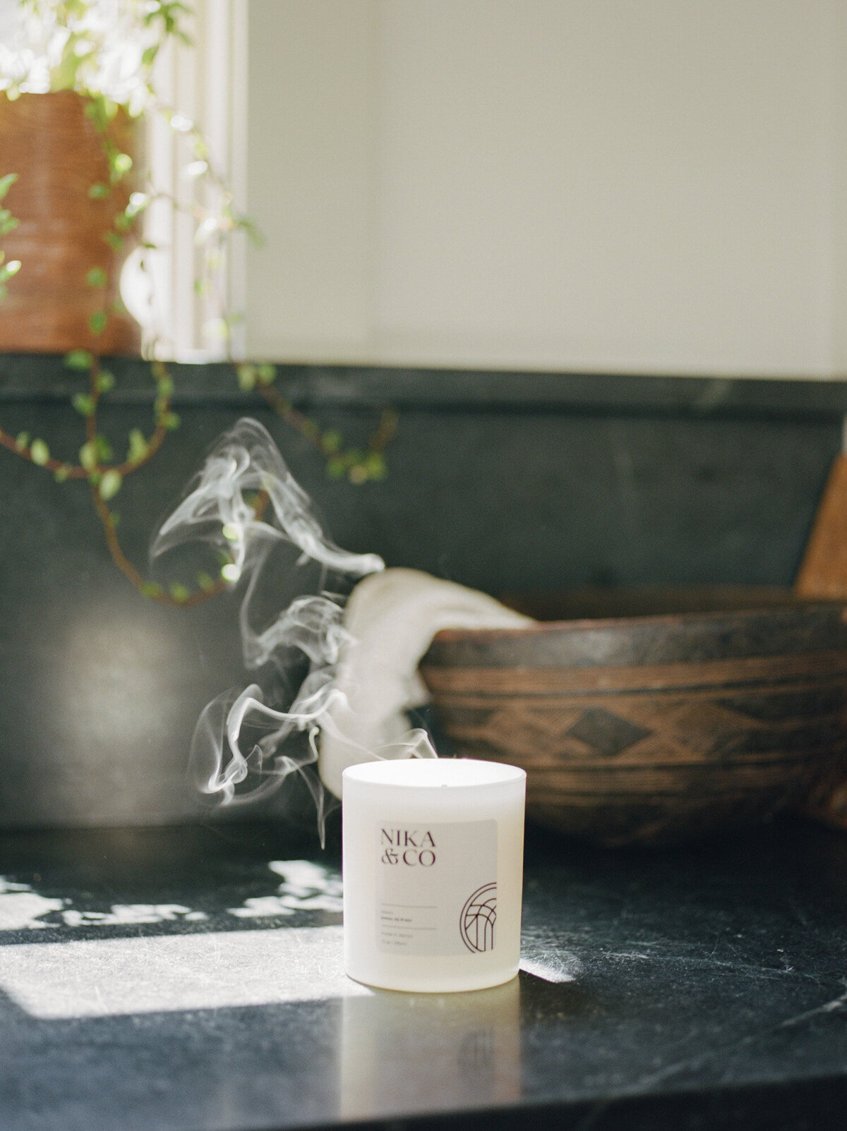 sunlit smoke rises from a freshly blown out candle, interior photography, lifestyle film photography, Fernhaus, Michigan