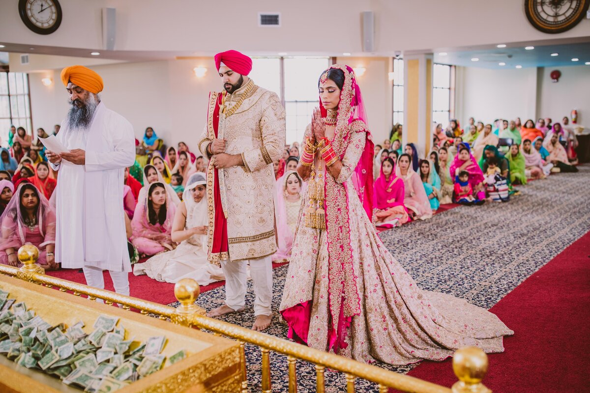 sikh bride and groom stand during the anand karaj wedding ceremony at glen cove ny