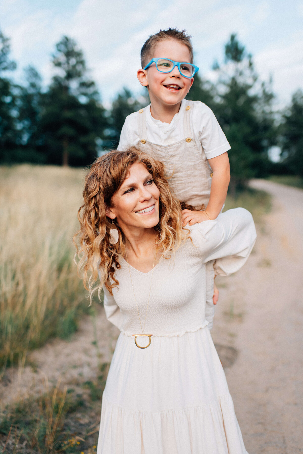 mom holding son on her back while he climbs up her back in denver