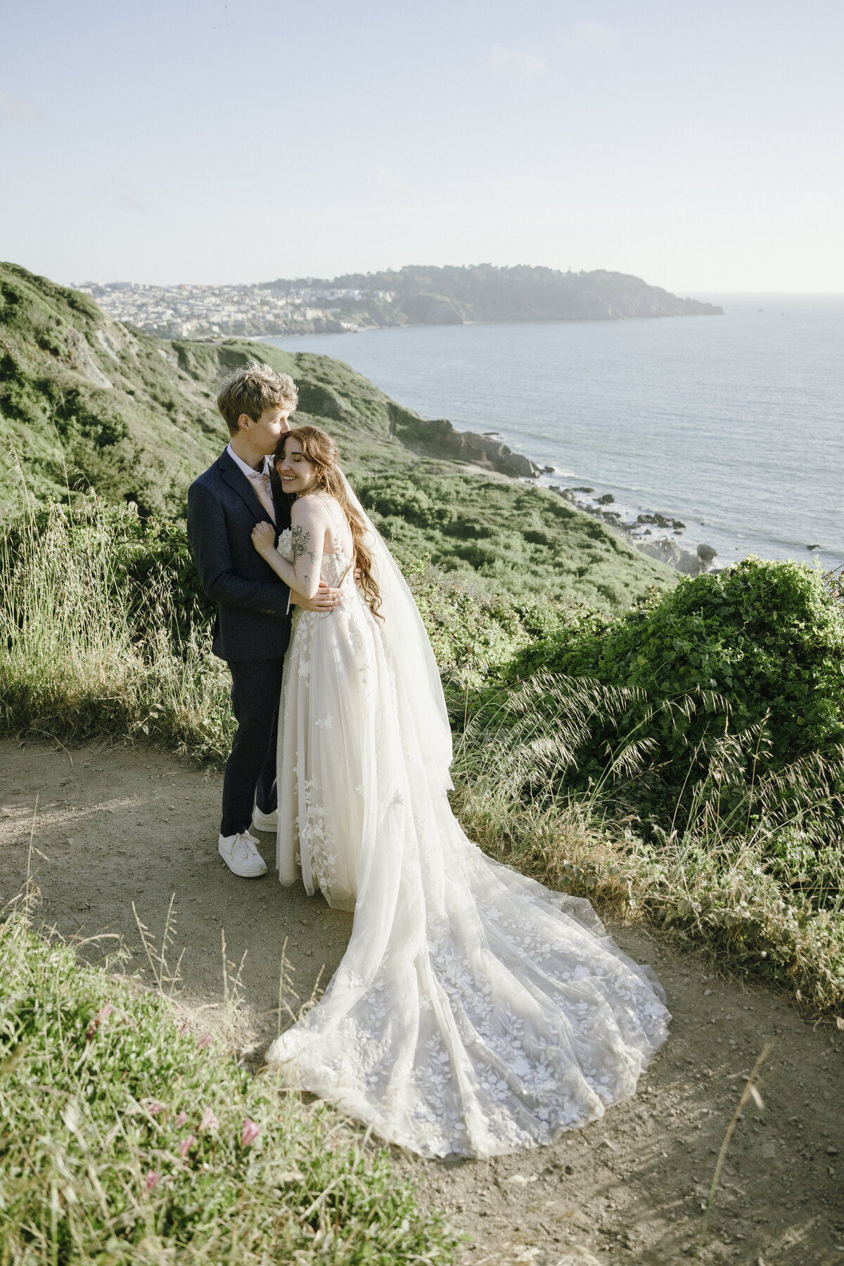  Bride and Groom at Marshall's Beach in San Francisco, California at sunset