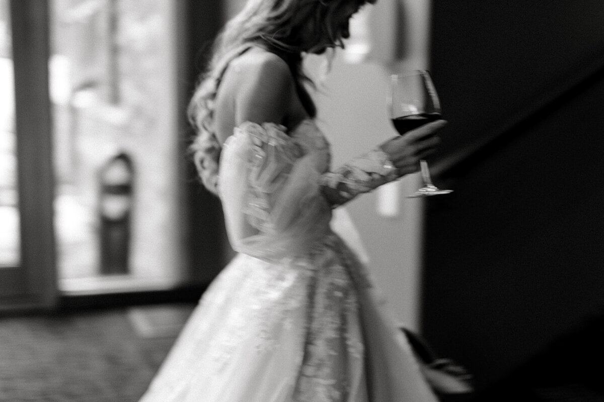 A moment captured between a bride and her wine