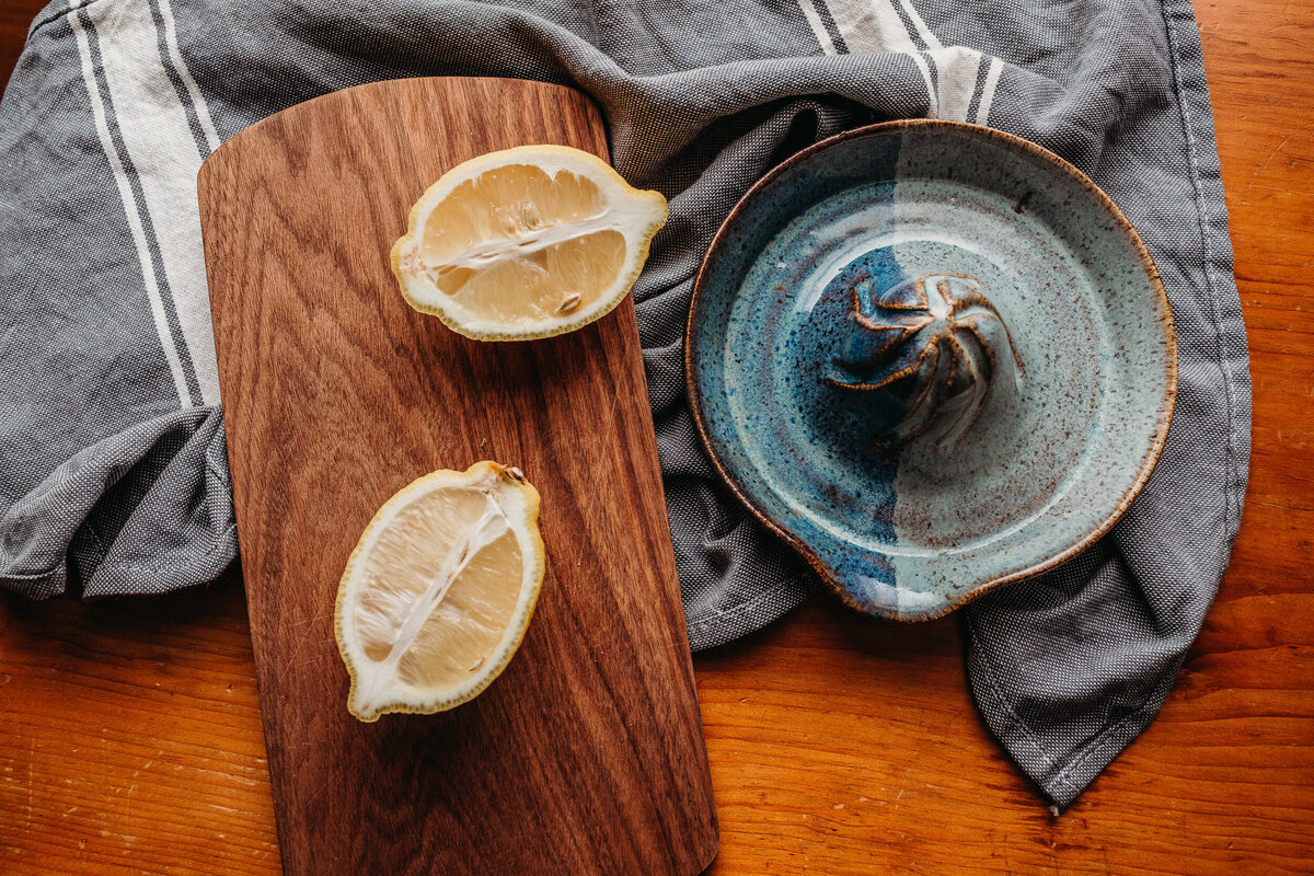overhead shot of pottery juicer with lemons