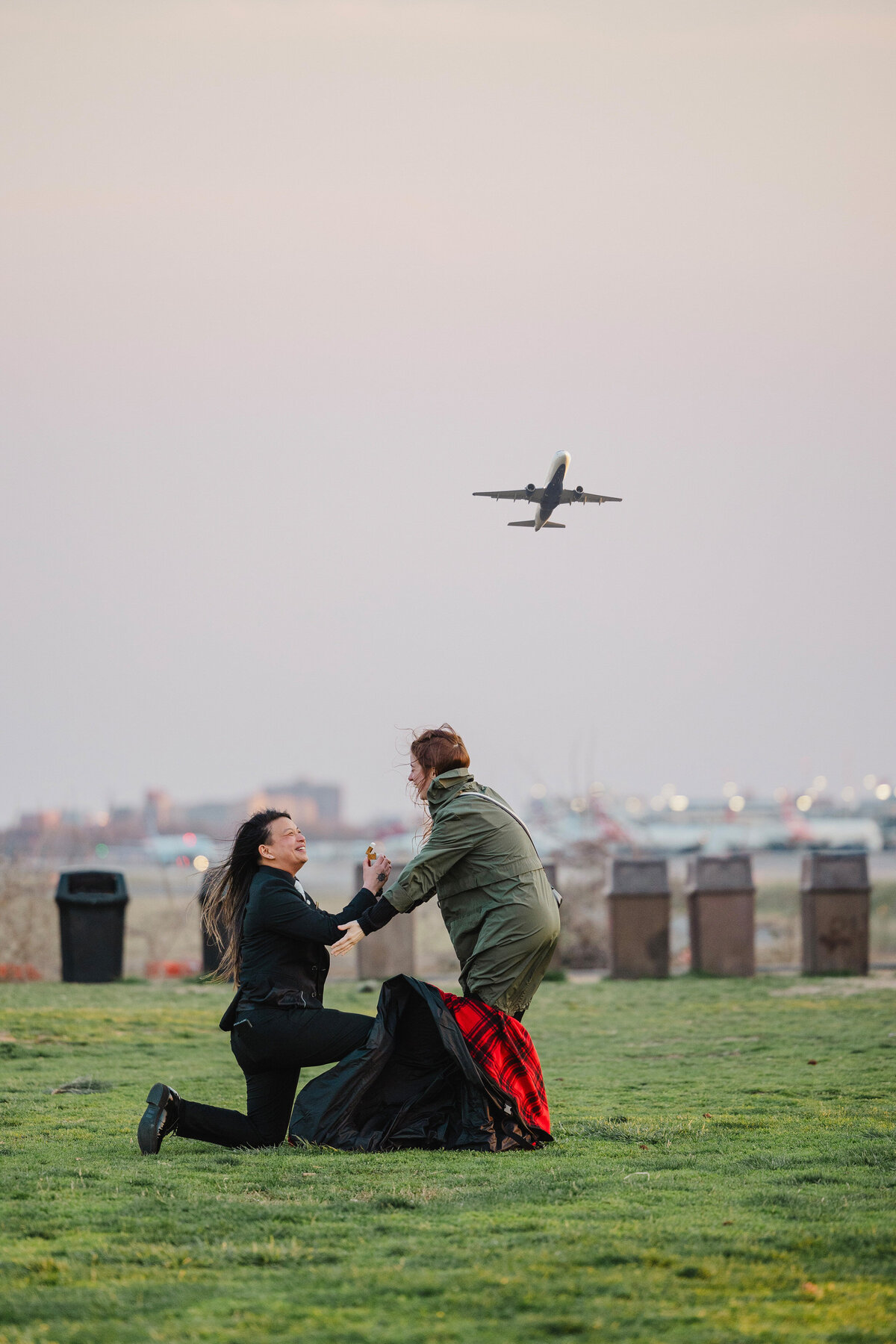 A proposal between a couple in DC as a plane flies overhead.