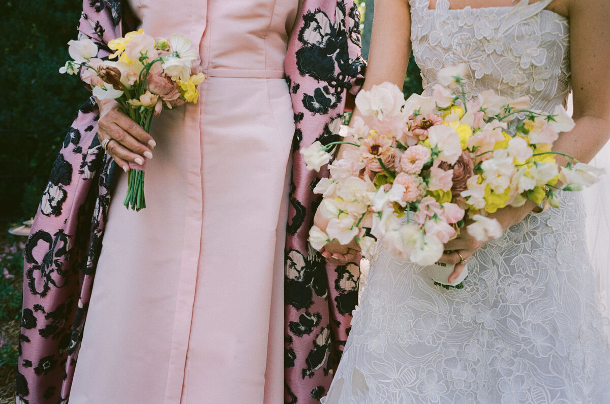 Product clustered bridal bouquet with sweet peas, local zinnias, and butterfly ranunculus. Elegant and simple bridal bouquet and bridal party bouquets with hues of blush and pops of yellow. Unique fall wedding design for private residence wedding in Nashville, TN. Bridal party wearing brown and wedding design with touches of brown. Design by Rosemary & Finch Floral Design in Nashville, TN.