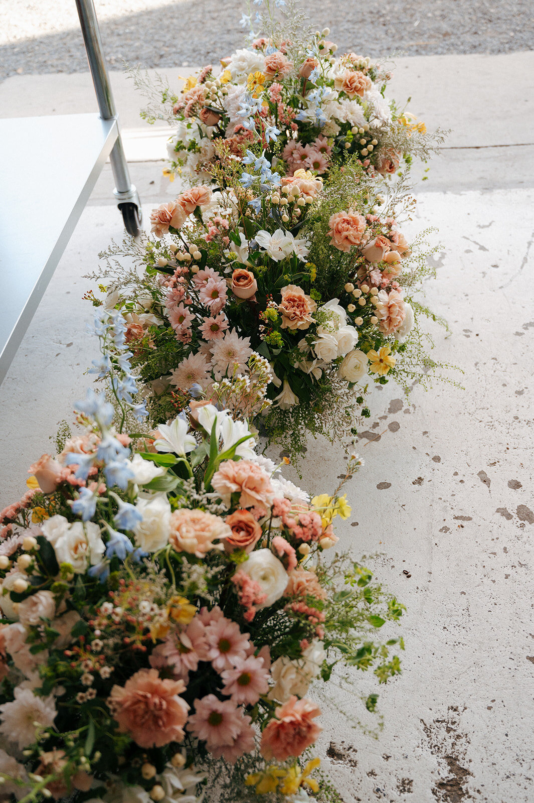 Flower arrangements lined up and ready for a vow renewal planned by Perfect Thirds and Co. 