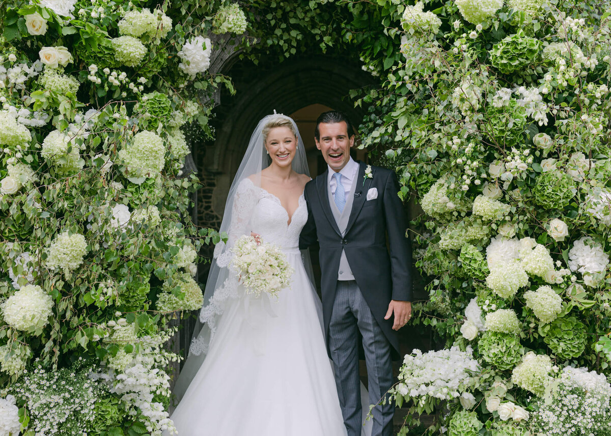 chloe-winstanley-weddings-hambleden-church-flower-arch-bride-groom