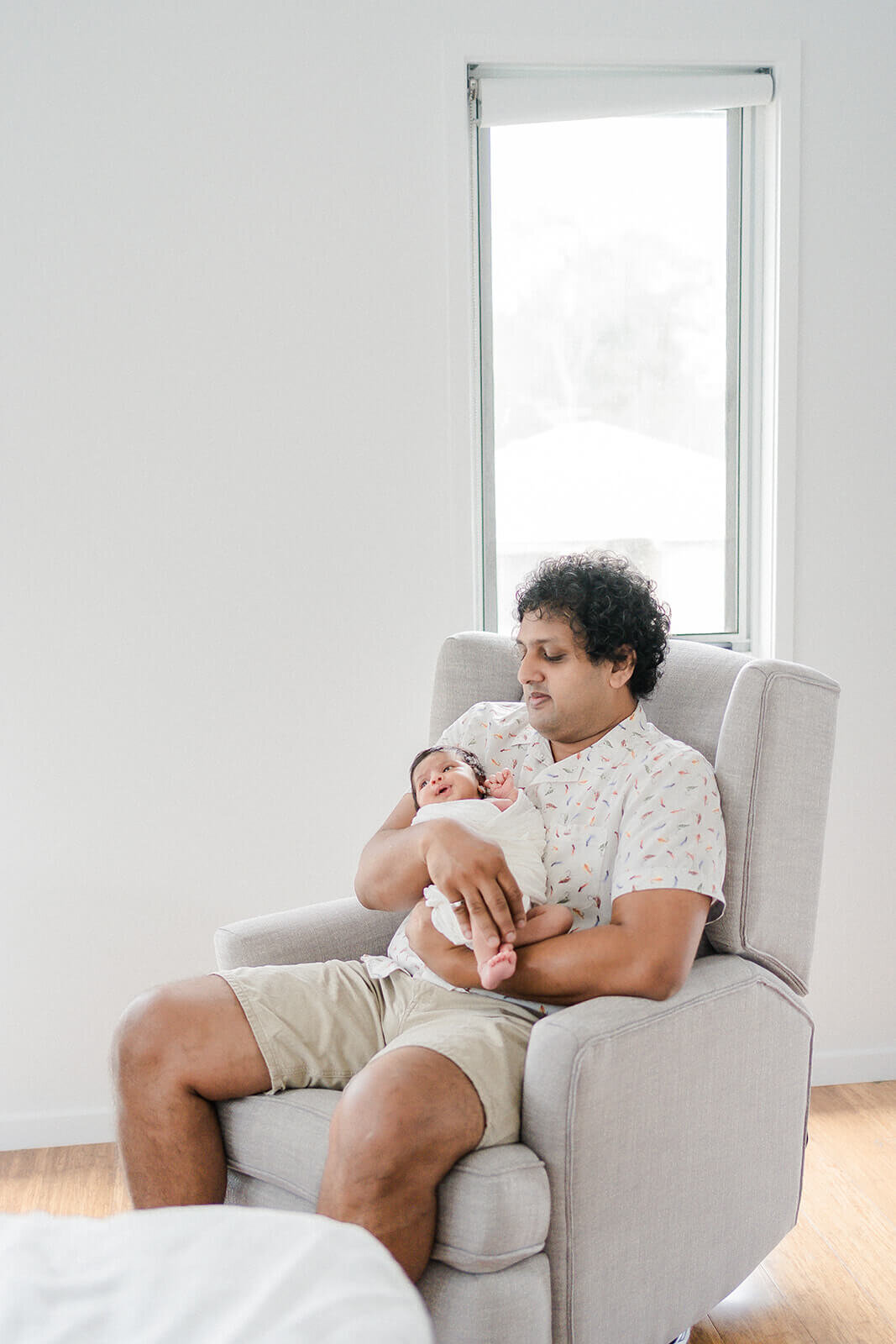 Intimate moments: dad and newborn captured in Gold Coast session at clients home.