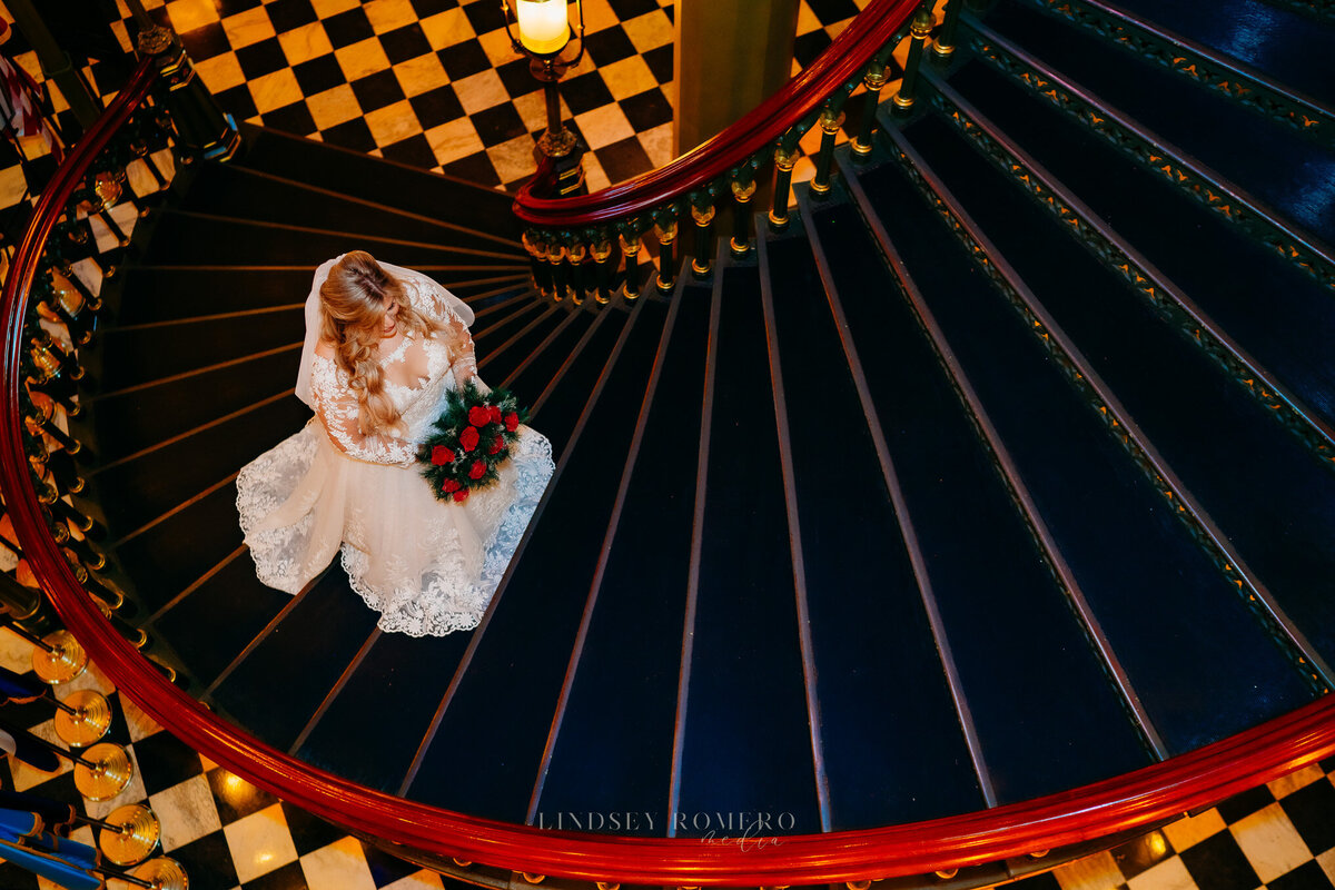 aerial shot of bride walking up spiral stairs at old state capital in baton rouge, la