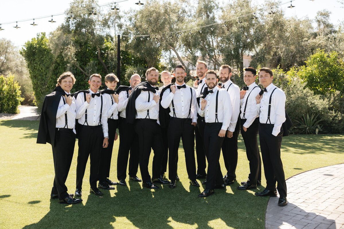 Groom and groomsmen posing for a portrait at El Chorro in Paradise Valley, Arizona