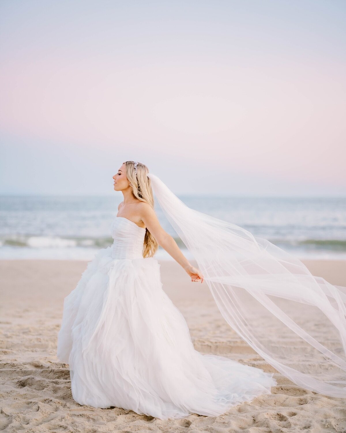 Bride on the beach at Montauk Wedding with veil blowing in the wind | Captured on film by Rhode Island Wedding Photographer, Deirdre Photography