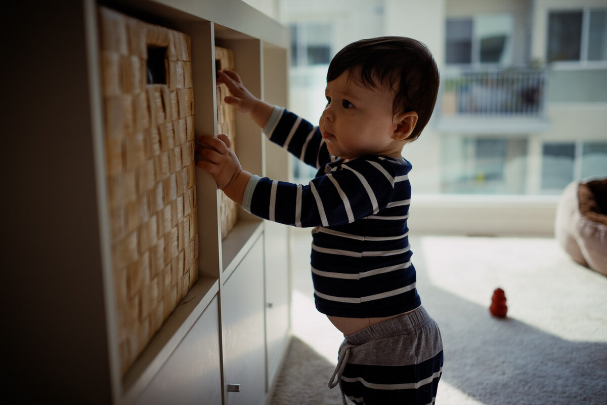 young boy explores bookshelves
