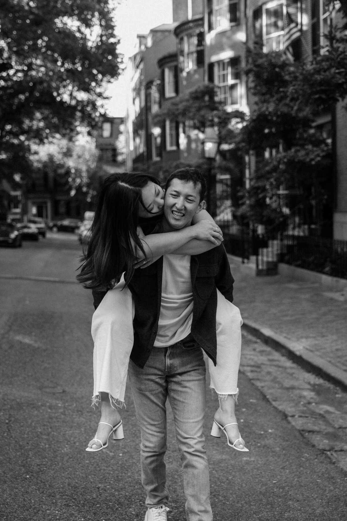 man holding woman in downtown boston