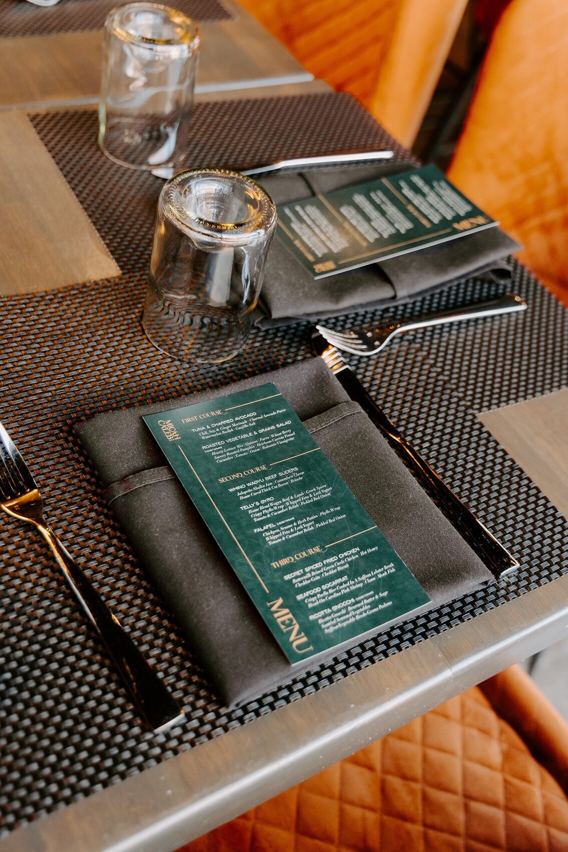 Wedding table with a grey napkin and green menu