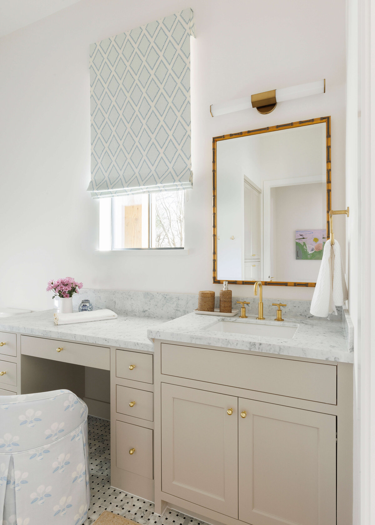 oyster creek studios missouri city new build tan bathroom with marble counters and gold mirror by window in bathroom