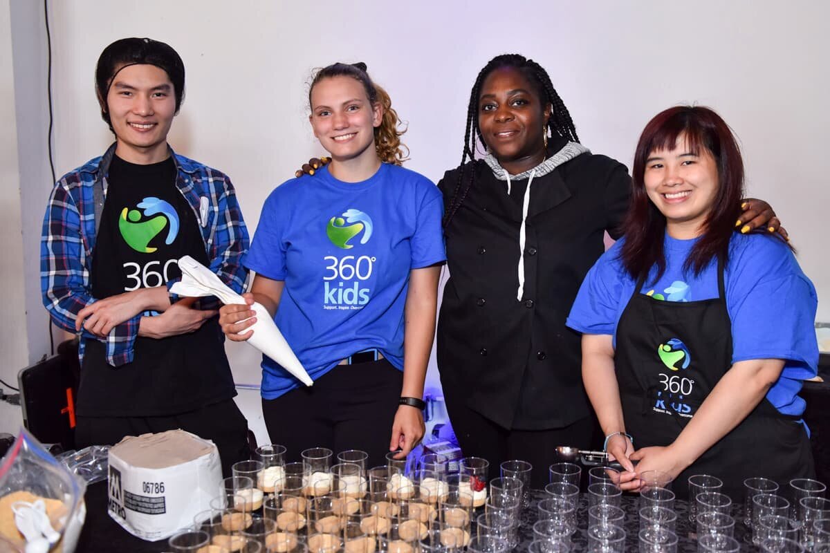 colleagues smiling and posing for a photo at a professional networking event