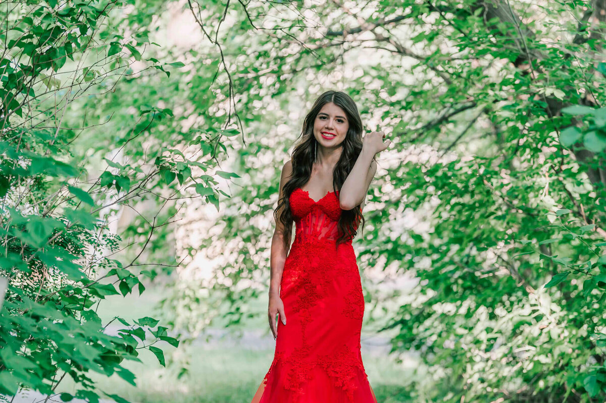 A beautiful girl standing iin some trees