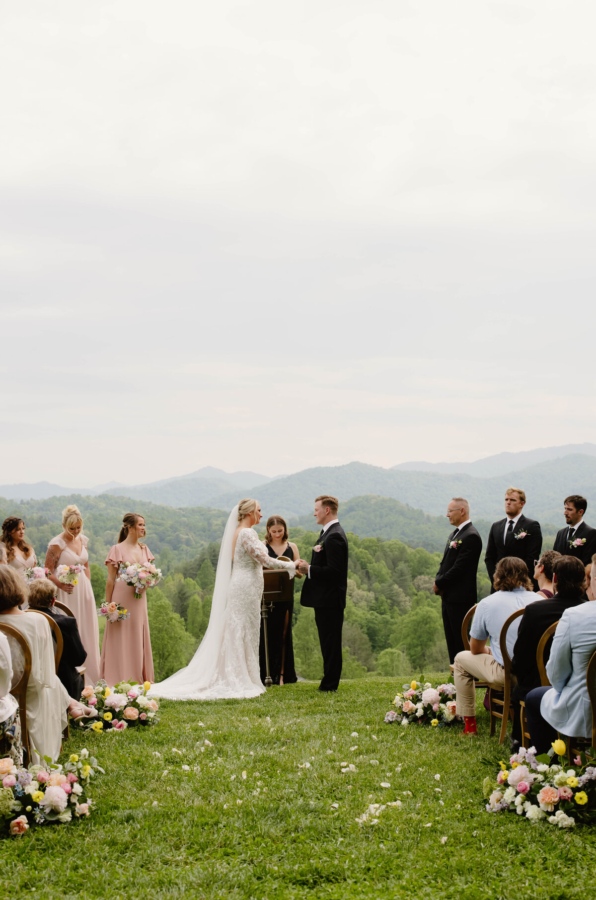 North Carolina wedding ceremony with colorful florals White and blue reception florals designed by Abby Grace Florals