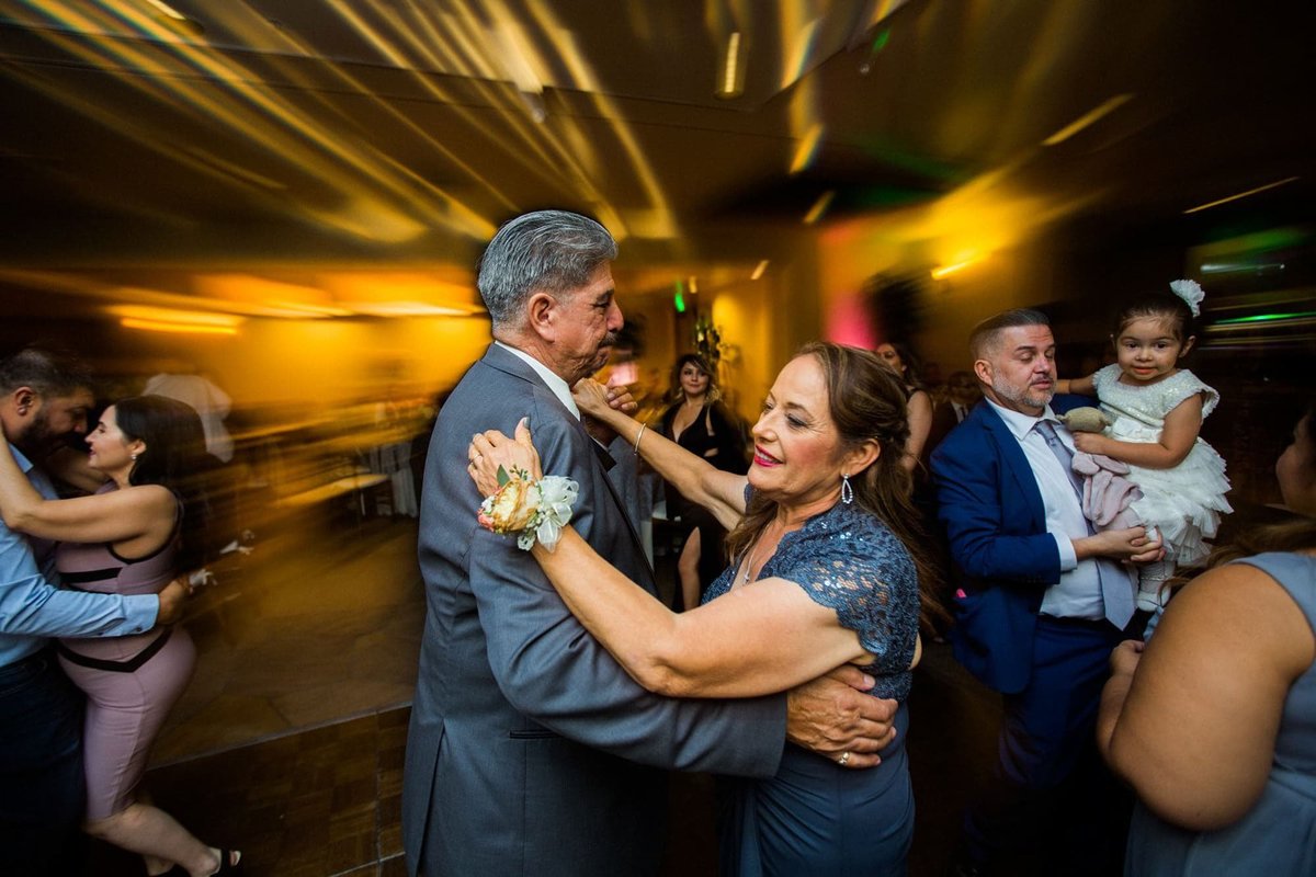 Parents of the Bride dance together at their daughter's wedding