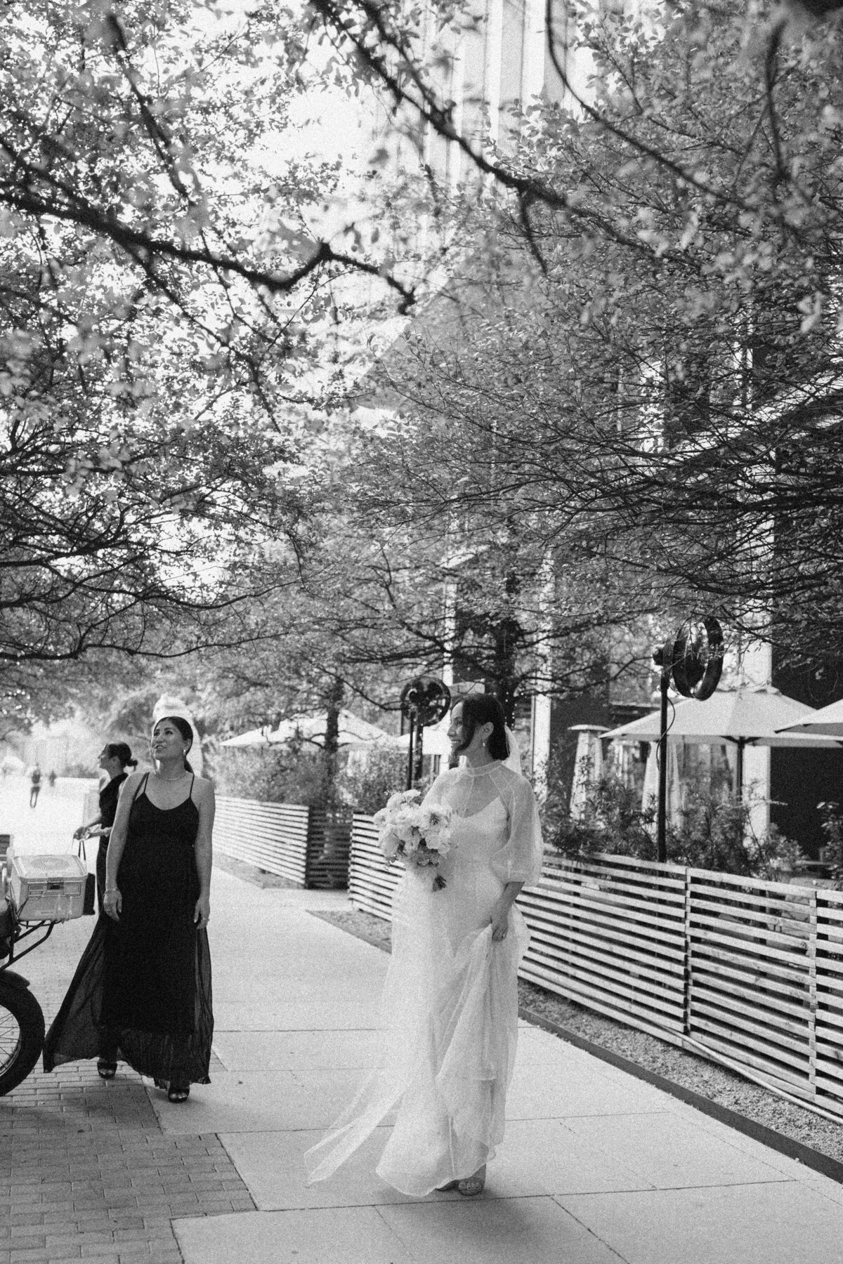 Bride walking along street in Austin for intimate wedding at Proper hotel