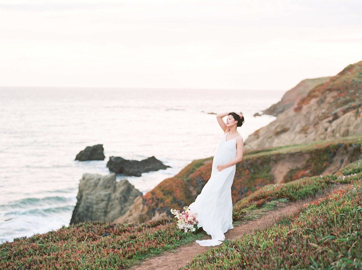 maternity photography in san francisco bay area with the wind blowing a woman's dress