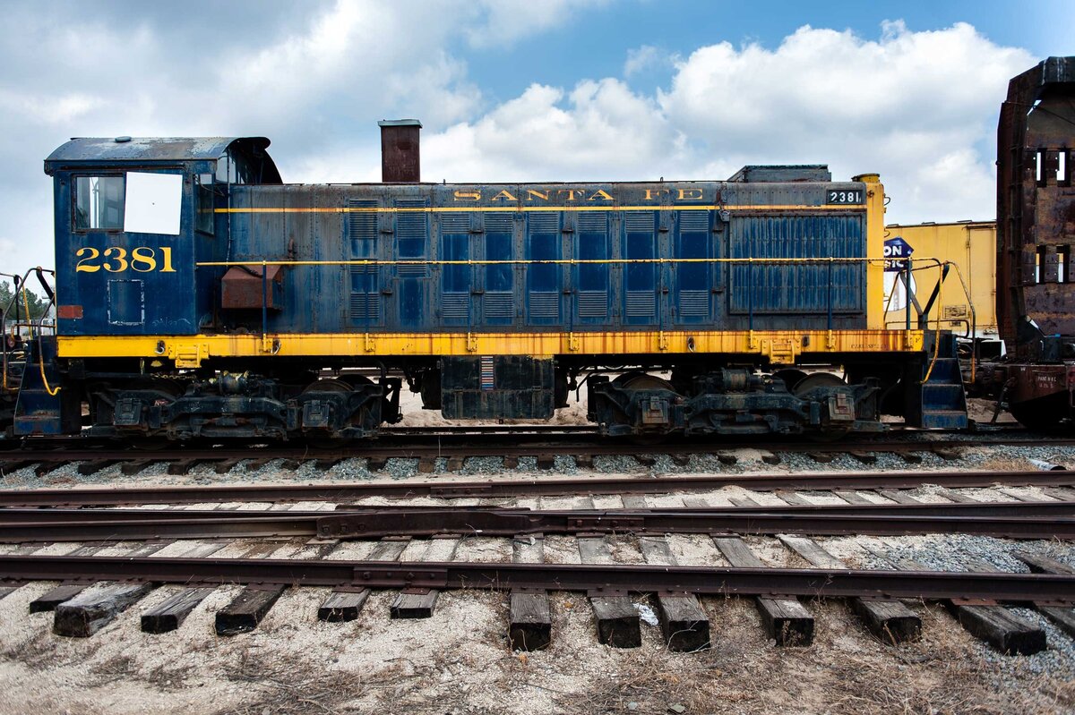 Old Santa Fe train profile shot as it rusts away  in train yard