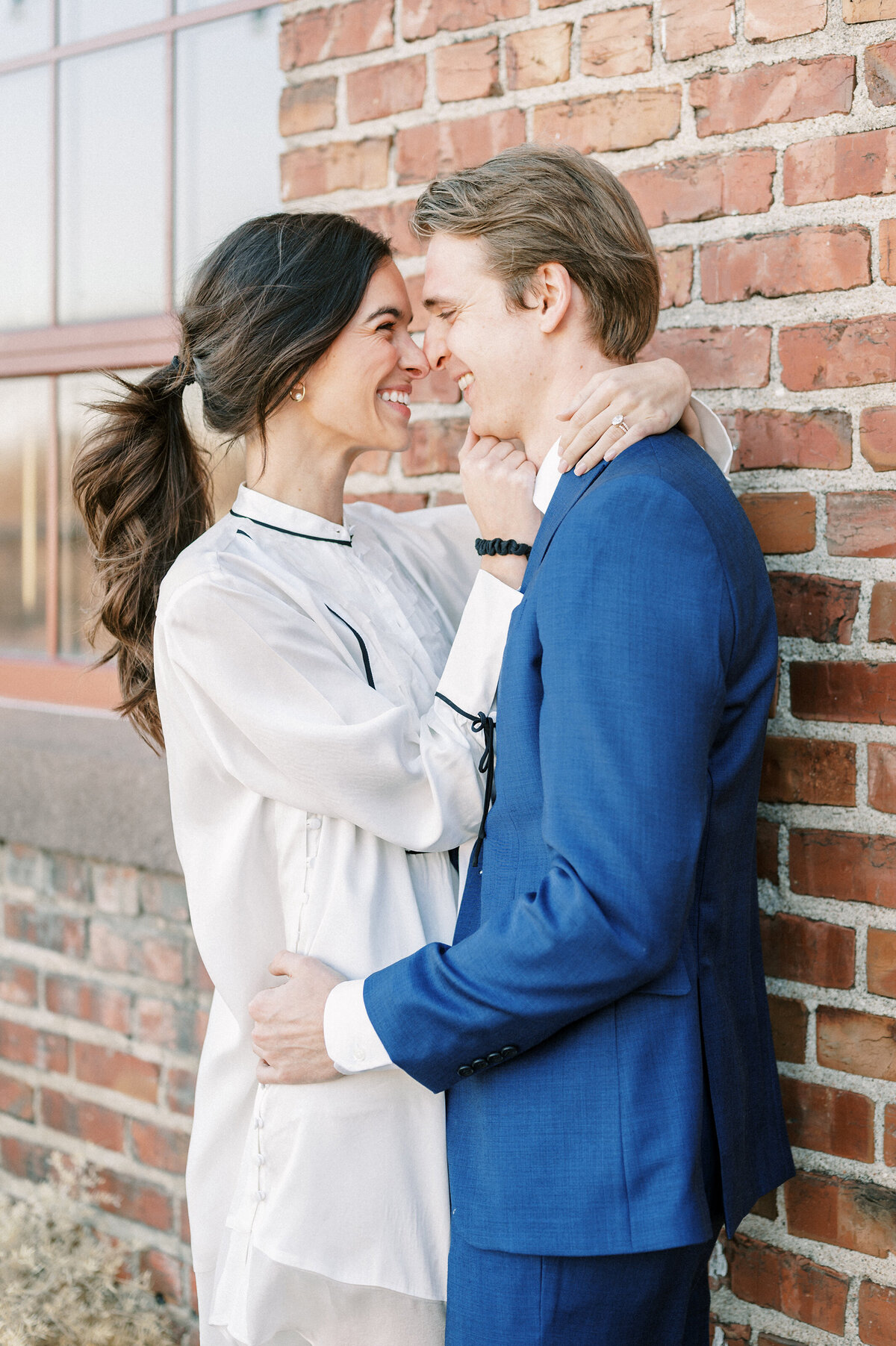 couple nose to nose at their engagement session in downtown Omaha